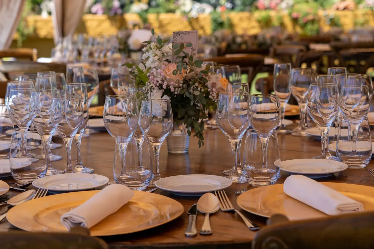Mesas de banquete de boda montadas con manteles blancos y copas